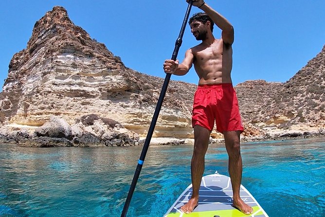 7 hours Boat trip to Lampedusa lunch, SUP and Snorkeling - The migration monument stop, a meaningful local pause