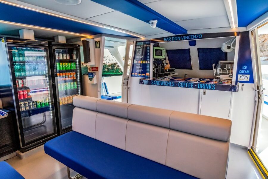 From Cala Gonone: Gulf of Orosei Cruise to Cala Goloritzè - Onboard setup: bar, snacks, audio guide, and family-friendly extras