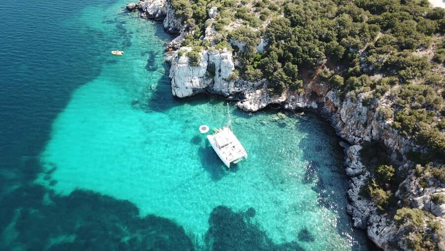 Porto Conte: Half-day catamaran tour with aperitif - Sailing to Capo Caccia, where the coast smells like the Mediterranean