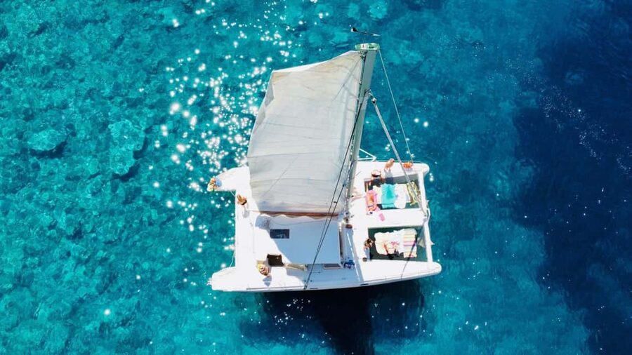 Porto Conte: Half-day catamaran tour with aperitif - Marina di Porto Conte, leftmost pier rules